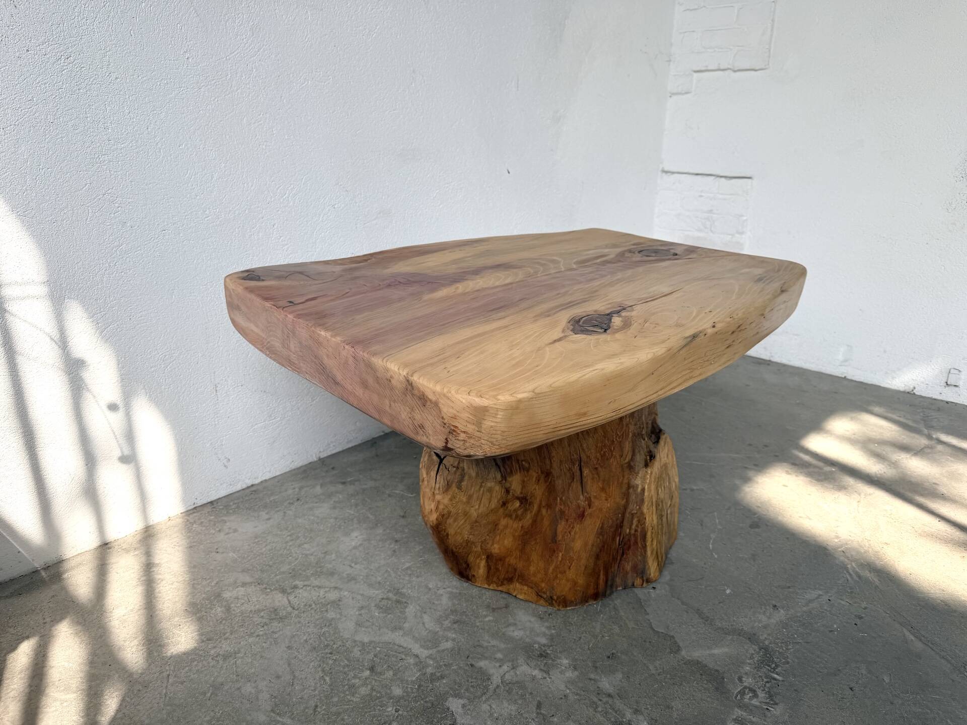 Organic brutalist coffee table in solid cedar, trunk pedestal, 1970s.