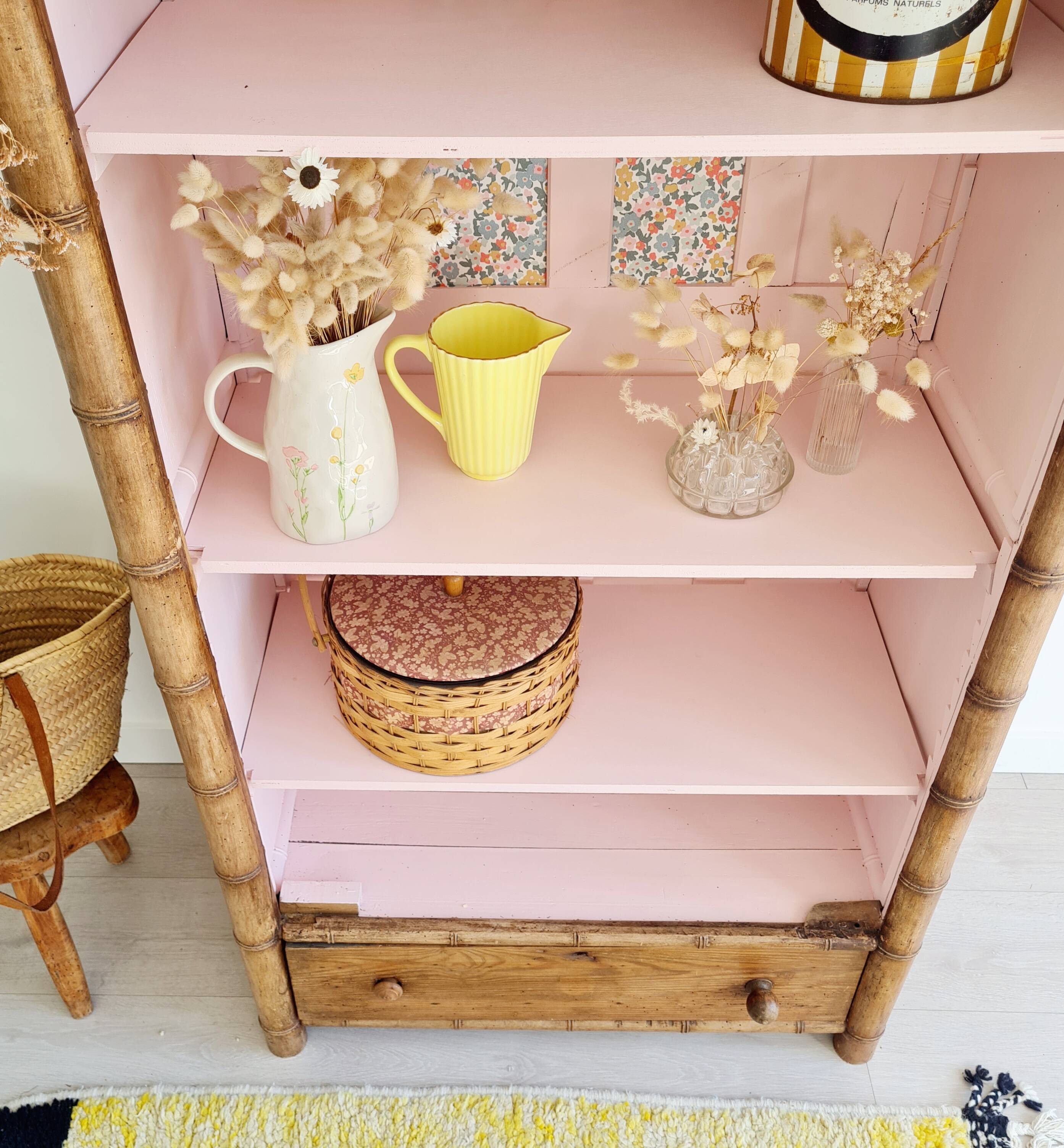 Library, old wooden cabinet imitating bamboo painted in pink