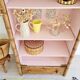 Library, old wooden cabinet imitating bamboo painted in pink