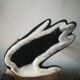 Black earthenware vase gloved hand