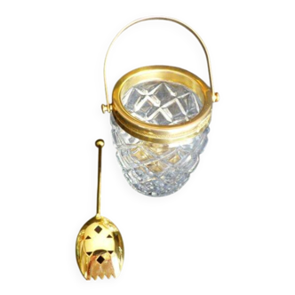 Glass and gold metal ice bucket with its gold metal spoon.