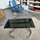 Table basse années 70 plateau de verre, piétement chromé avec porte-revues