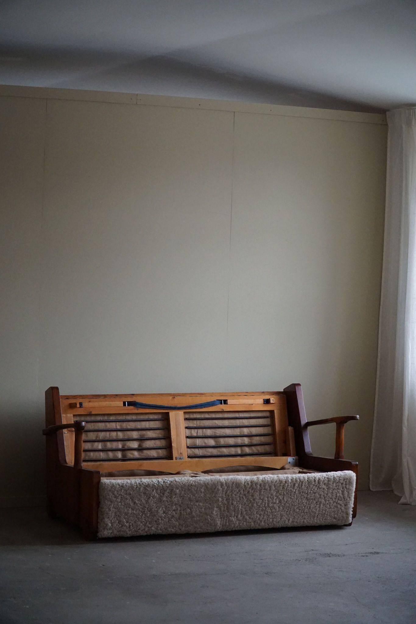 Modern Swedish two-seater independent sofa bed in pine and lambswool, 1950s.