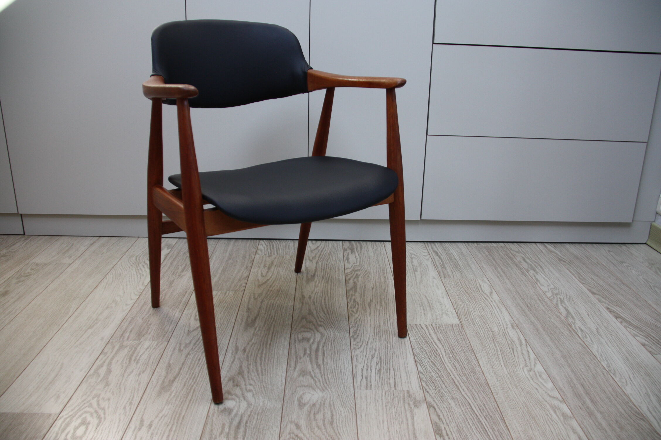 Vintage armchair in teak and black leather model Casina 60s