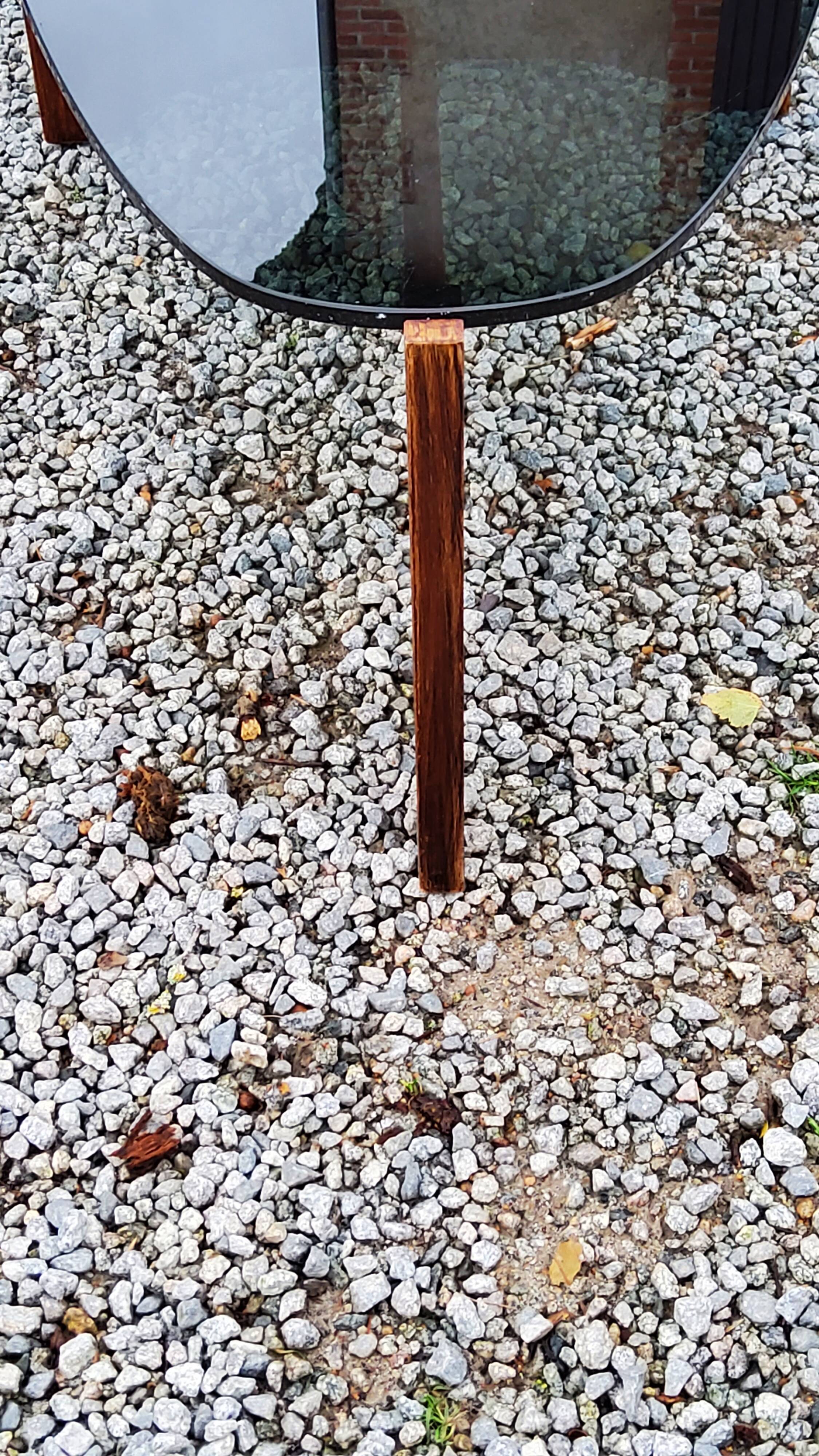 Designer coffee table by Hugues Poignant in rosewood and smoked glass from the 70s