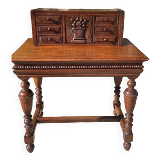 Tiered desk in solid oak, richly carved and molded, 19th century