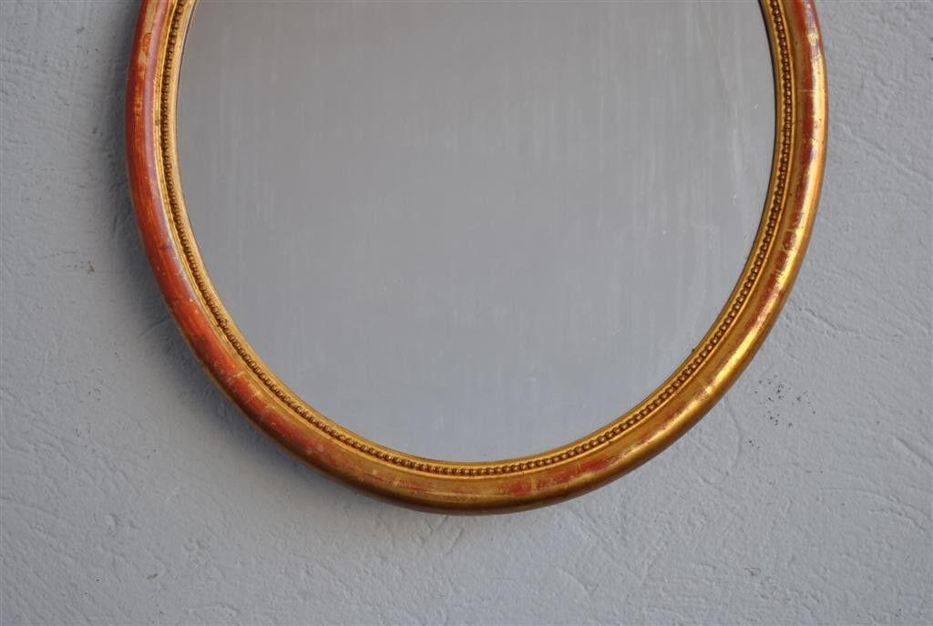 Golden stucco oval mirror