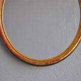 Golden stucco oval mirror