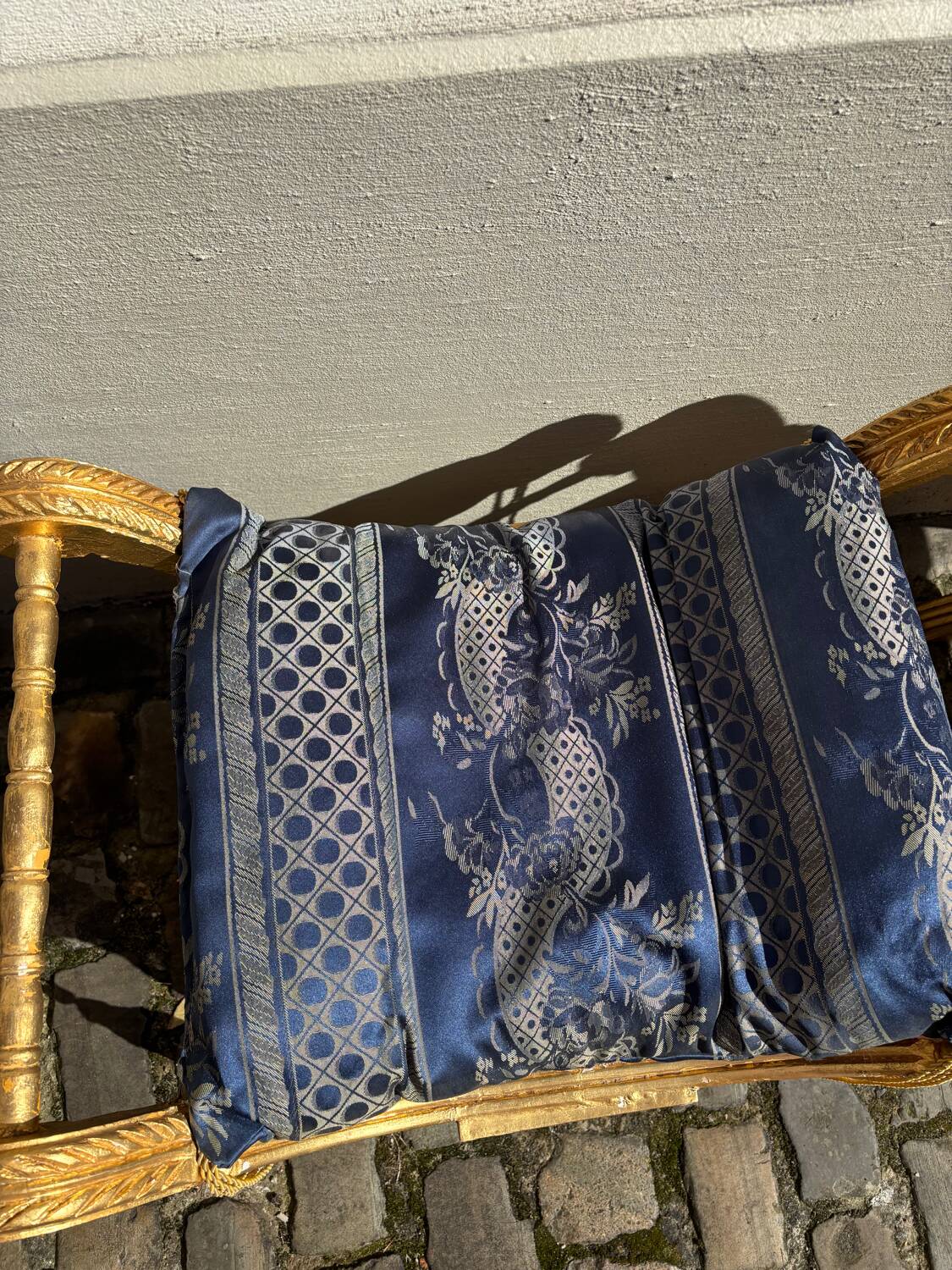 2 wooden footrests with blue cushions