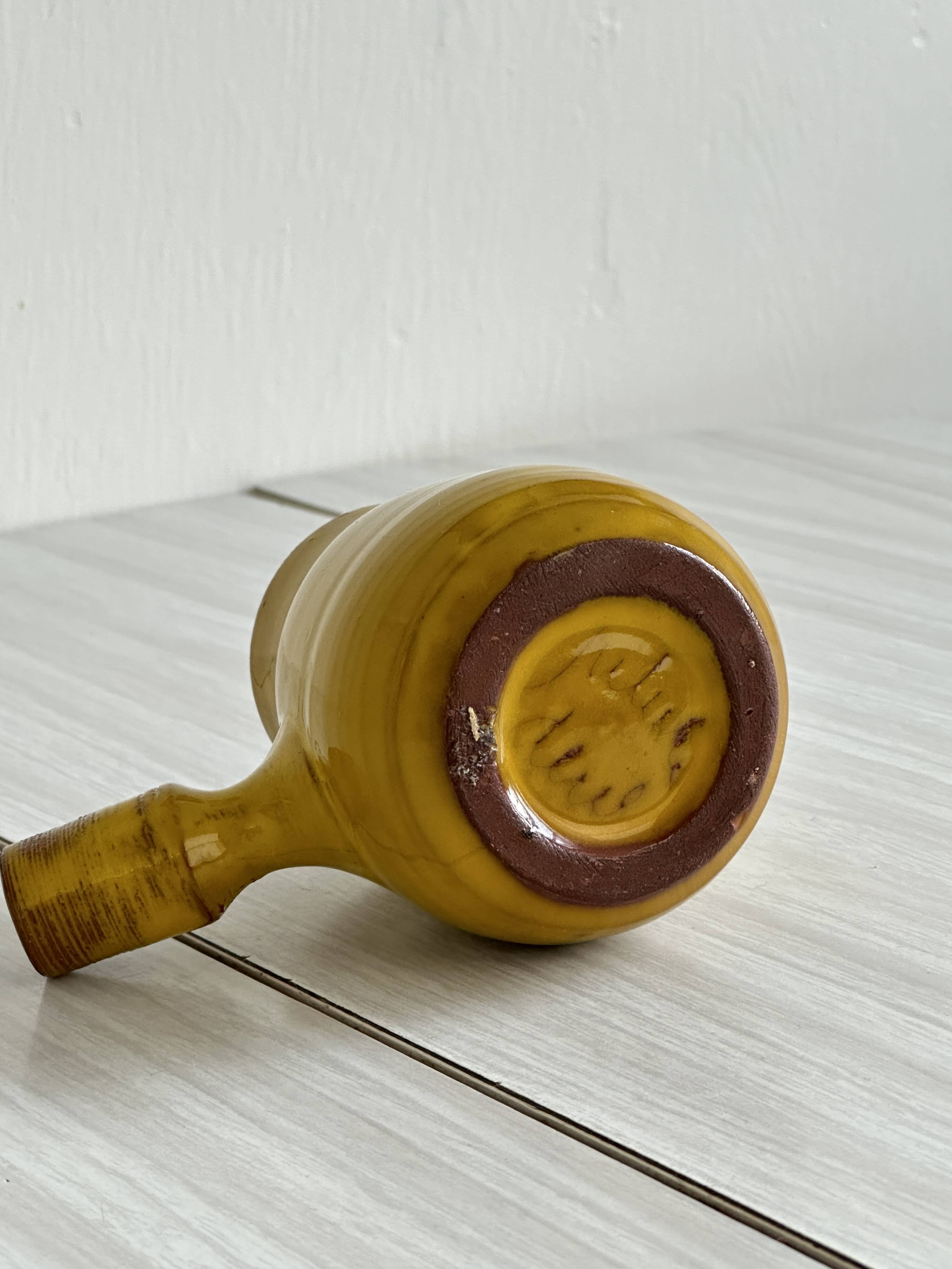 Yellow glazed ceramic sauce boat or milk jug