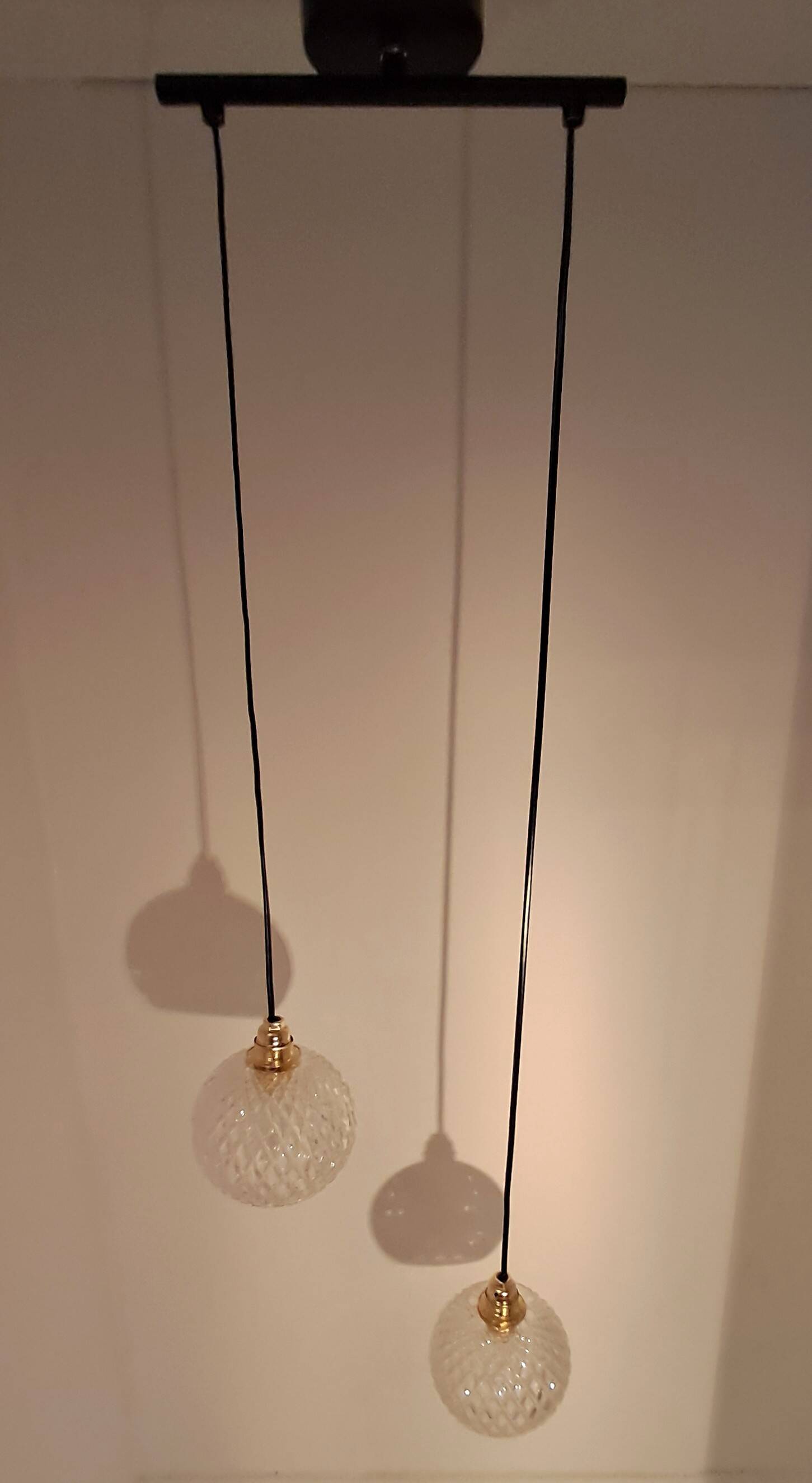 Two-light pendant in a cascade of cut crystal globe