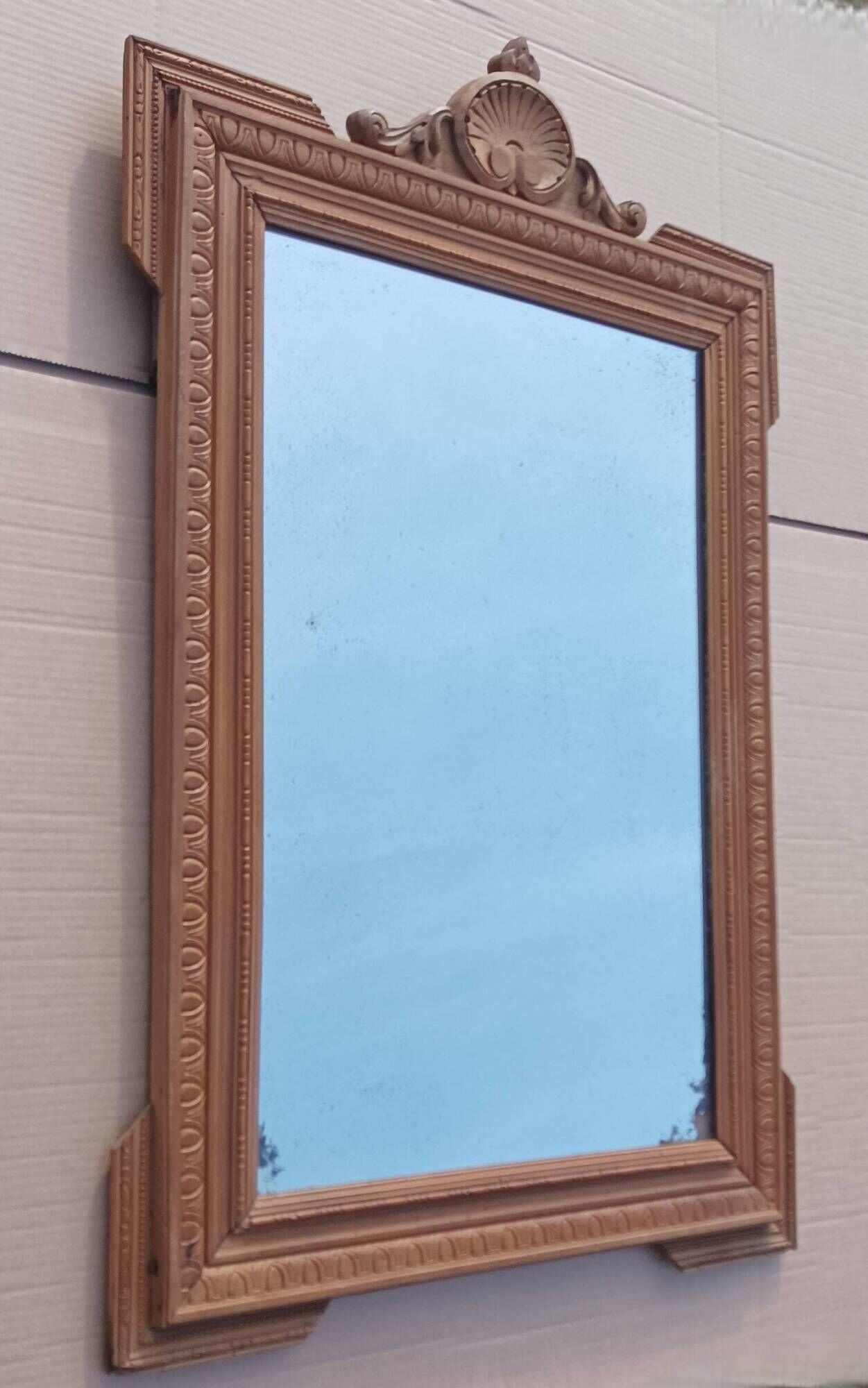 Louis XVI mirror in carved wood, 19th century.
