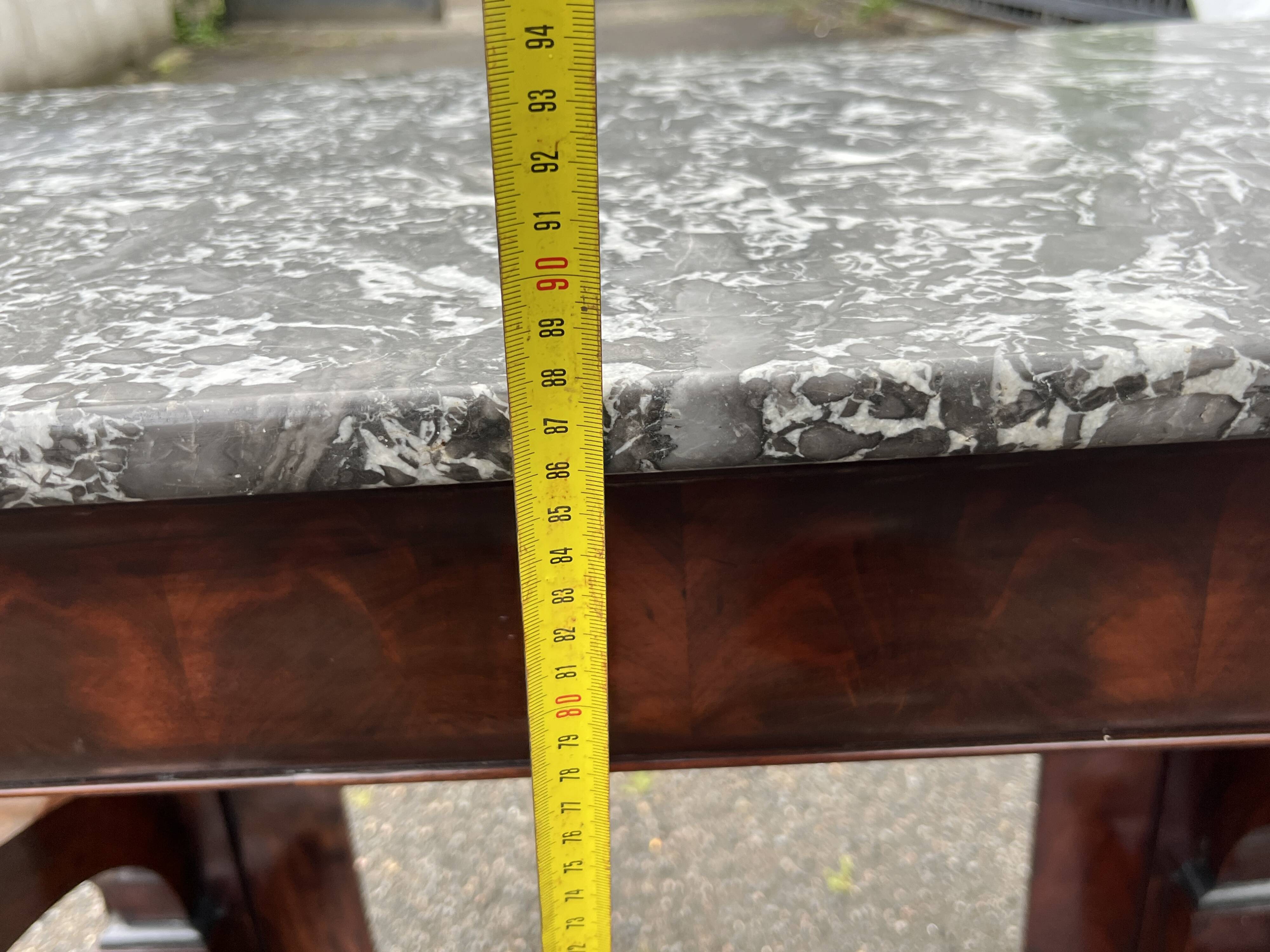 Mahogany console with grey marble top and lion paw feet.