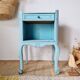 Small vintage bedside table in azure blue patina.
