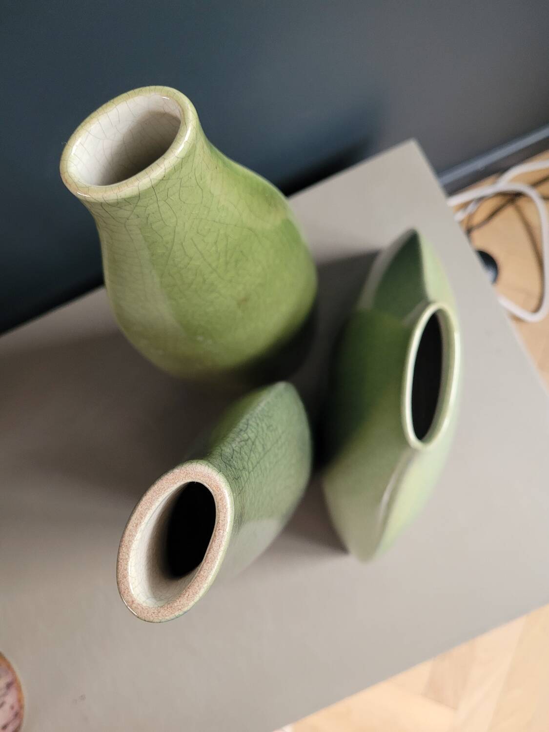 Trio of green enamelled vases