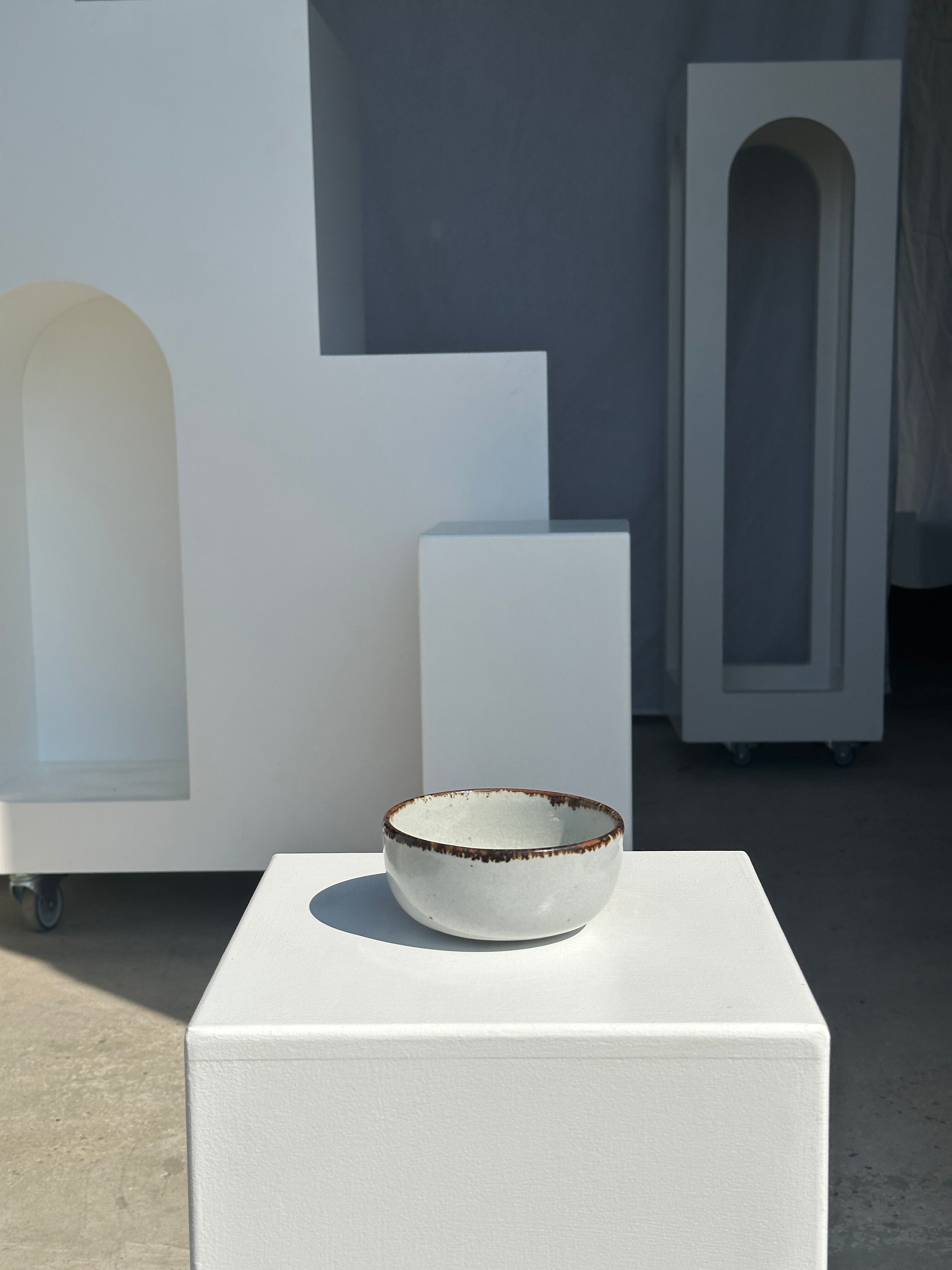 Small white glazed ceramic bowl black edges