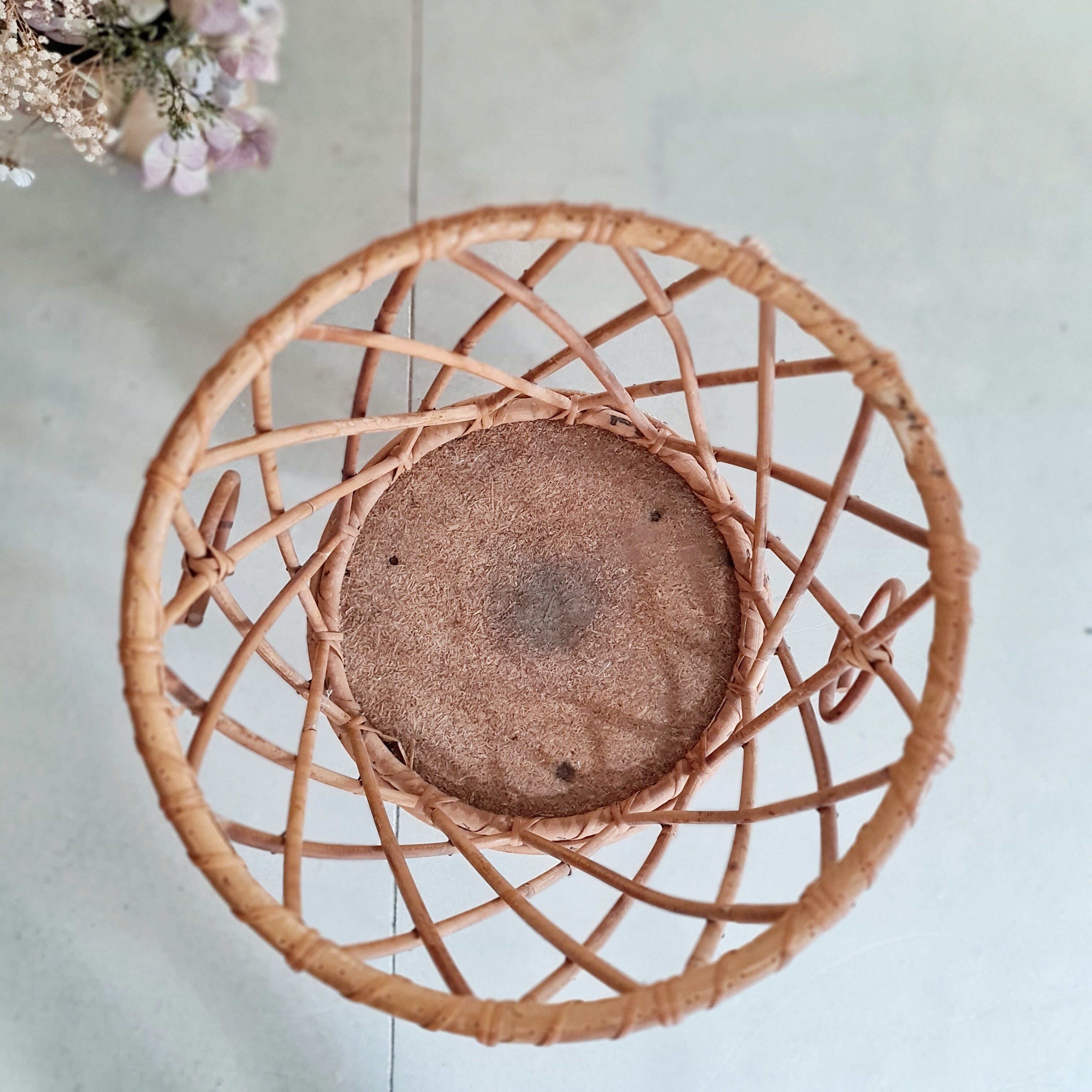 Old tripod rattan plant holder
