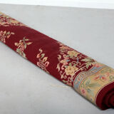 China wool fringed rug with floral pattern on deep plum background 393x274cm