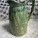 Turquoise green enamelled ceramic pitcher