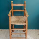 Children's high chair made of wood and straw