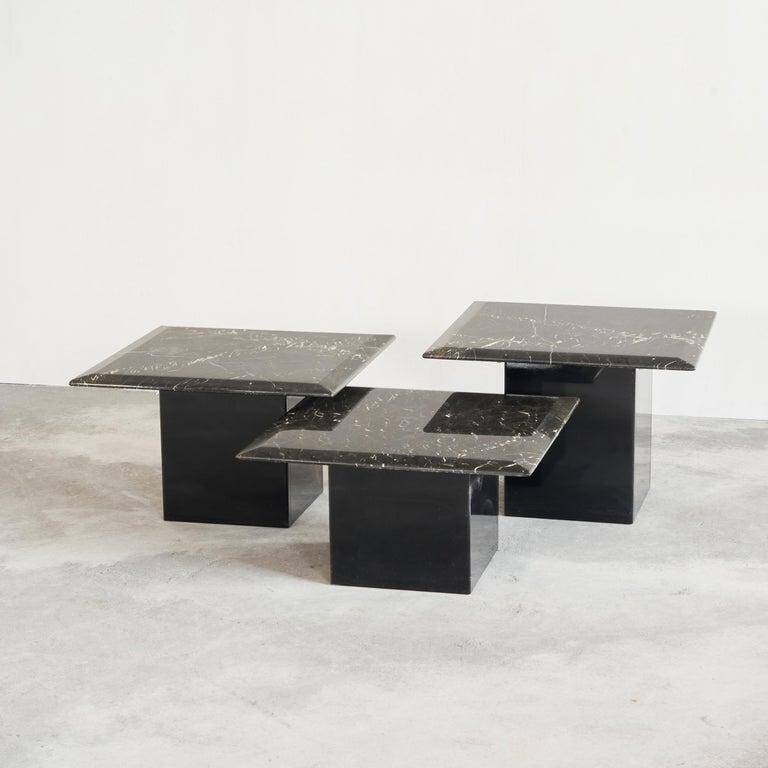 Set of 3 marble and lacquer coffee tables, 1970s.