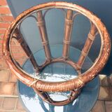 Round table in rattan and glass