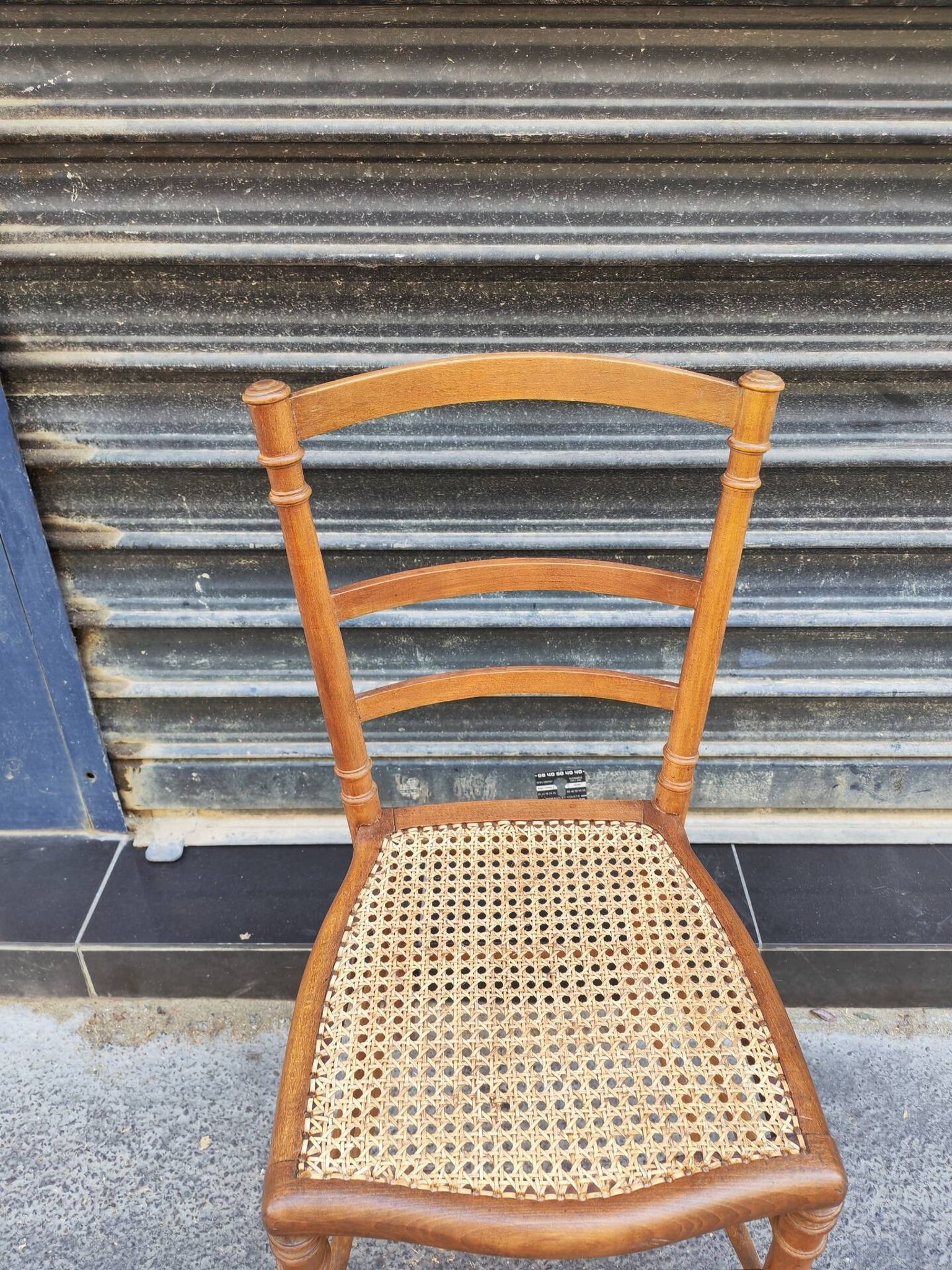 Antique wooden chair with cane seating