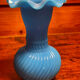 Blue opaline vase, opaque glass, wavy neck/rim, relief decoration of a bow.