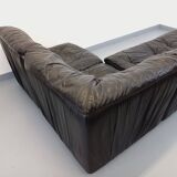 Vintage corner sofa composed of 3 modules in black leather with integrated bed.
