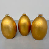 Vintage Italian design coffee table with a glass top and gold base, dating from the 1980s.