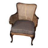 Chair with cane back and recently reupholstered fabric seat.