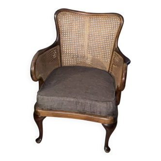 Chair with cane back and recently reupholstered fabric seat.