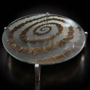 Round coffee table with double glass top, spiral carved decoration.