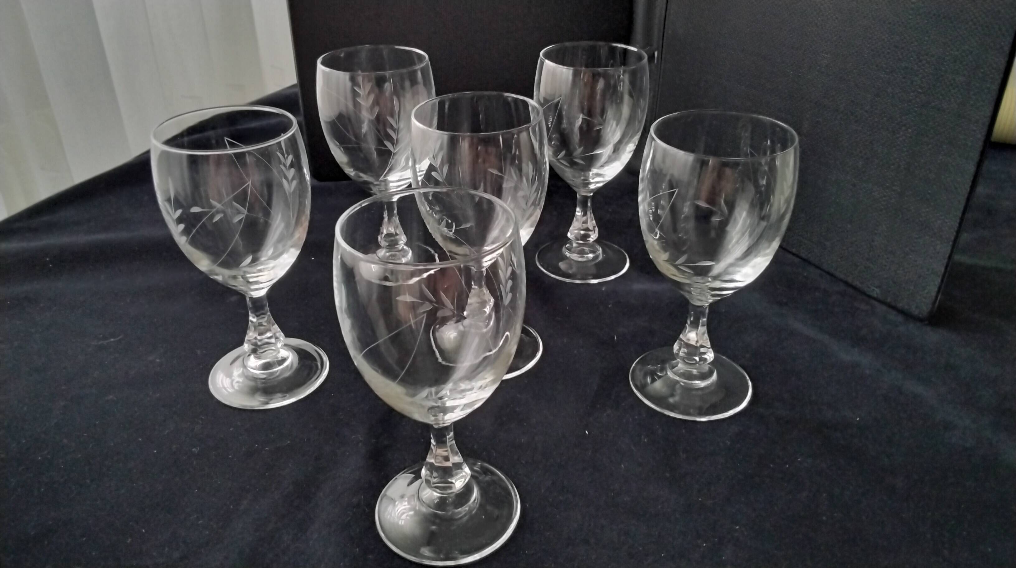 6 vintage wine glasses with baluster stems and engraved decoration on the bowl.