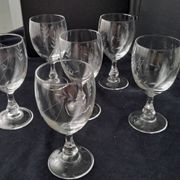 6 vintage wine glasses with baluster stems and engraved decoration on the bowl.