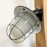 Industrial black enamel and cast iron wall lamp with iron grid, 1960s