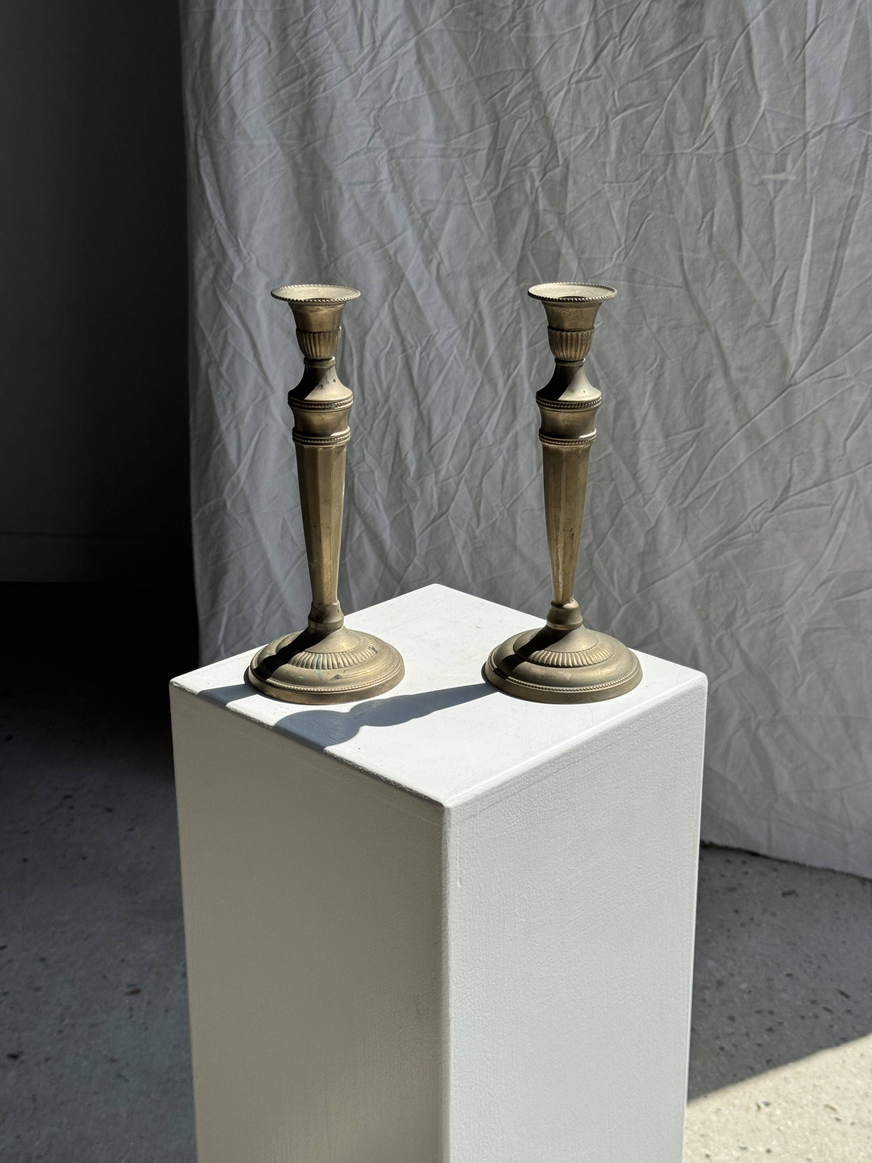 Pair of classic candlesticks in patinated gold metal H25