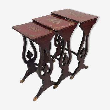 Series of three red lacquered nesting tables with gold decoration in Asian style, nineteenth