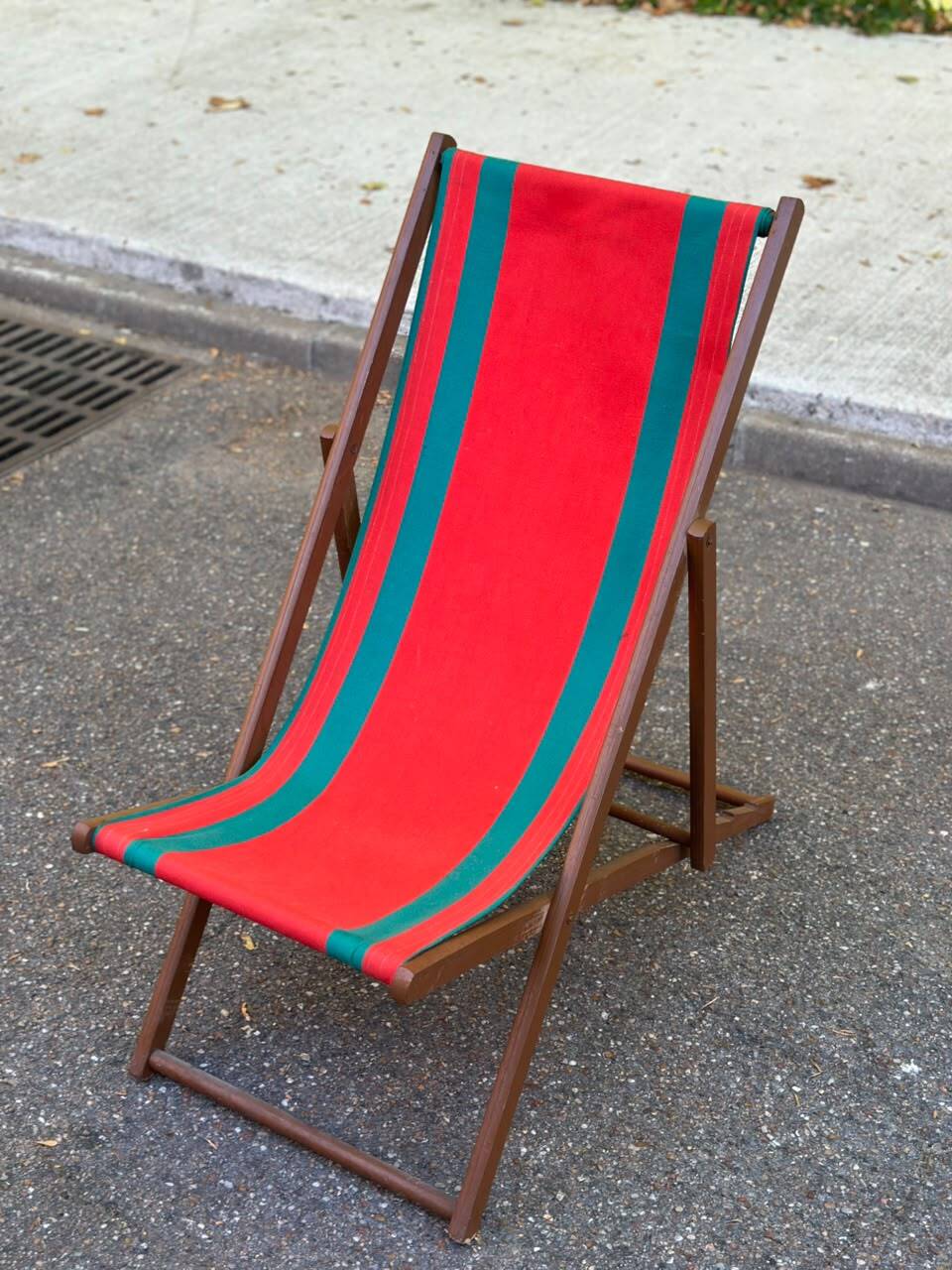 Vintage folding wooden deck chair with red and green striped canvas from the 1970s.