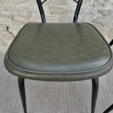 Black metal chairs with khaki faux leather seats, circa 1960.