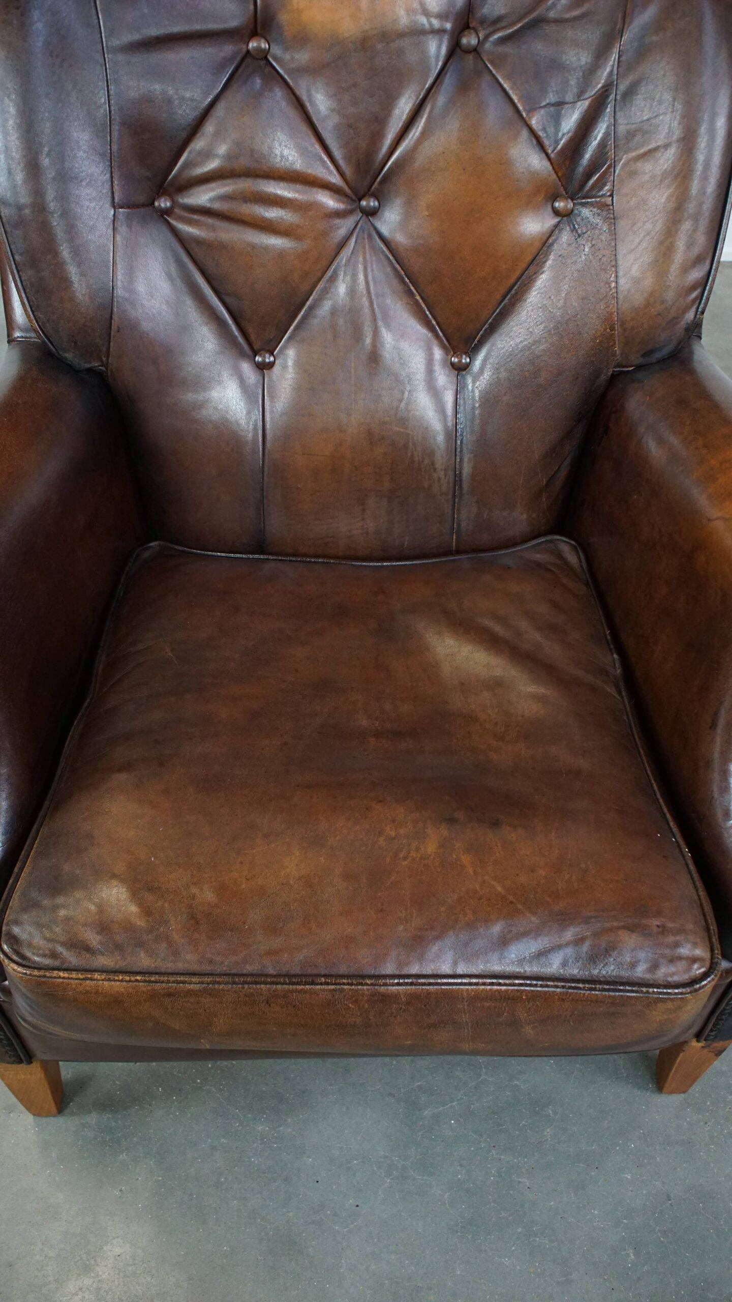 Vintage sheepskin armchair in a dark cognac colour with a comfortable seat