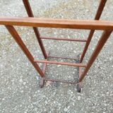 Valet wearing double wood coat rack