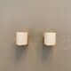 Wall lamps with milky white acrylic plastic shades and solid brass bases