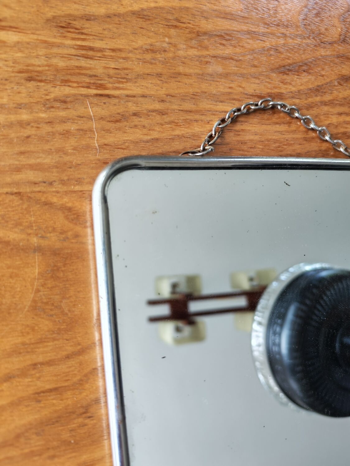 Vintage barber mirror with chain.