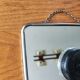 Vintage barber mirror with chain.