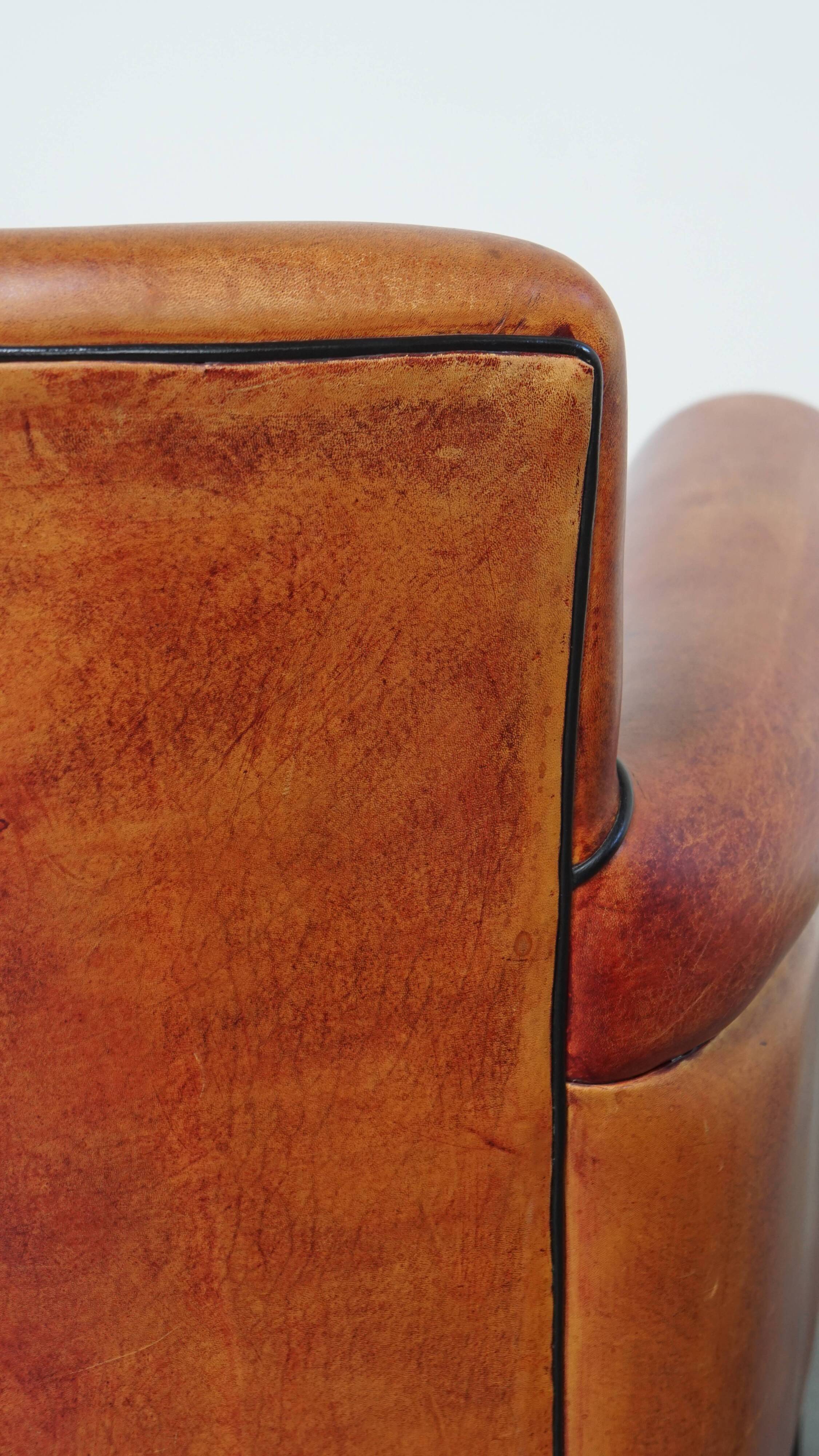 Armchair made of sheepskin leather in a red/brown color