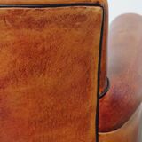Armchair made of sheepskin leather in a red/brown color
