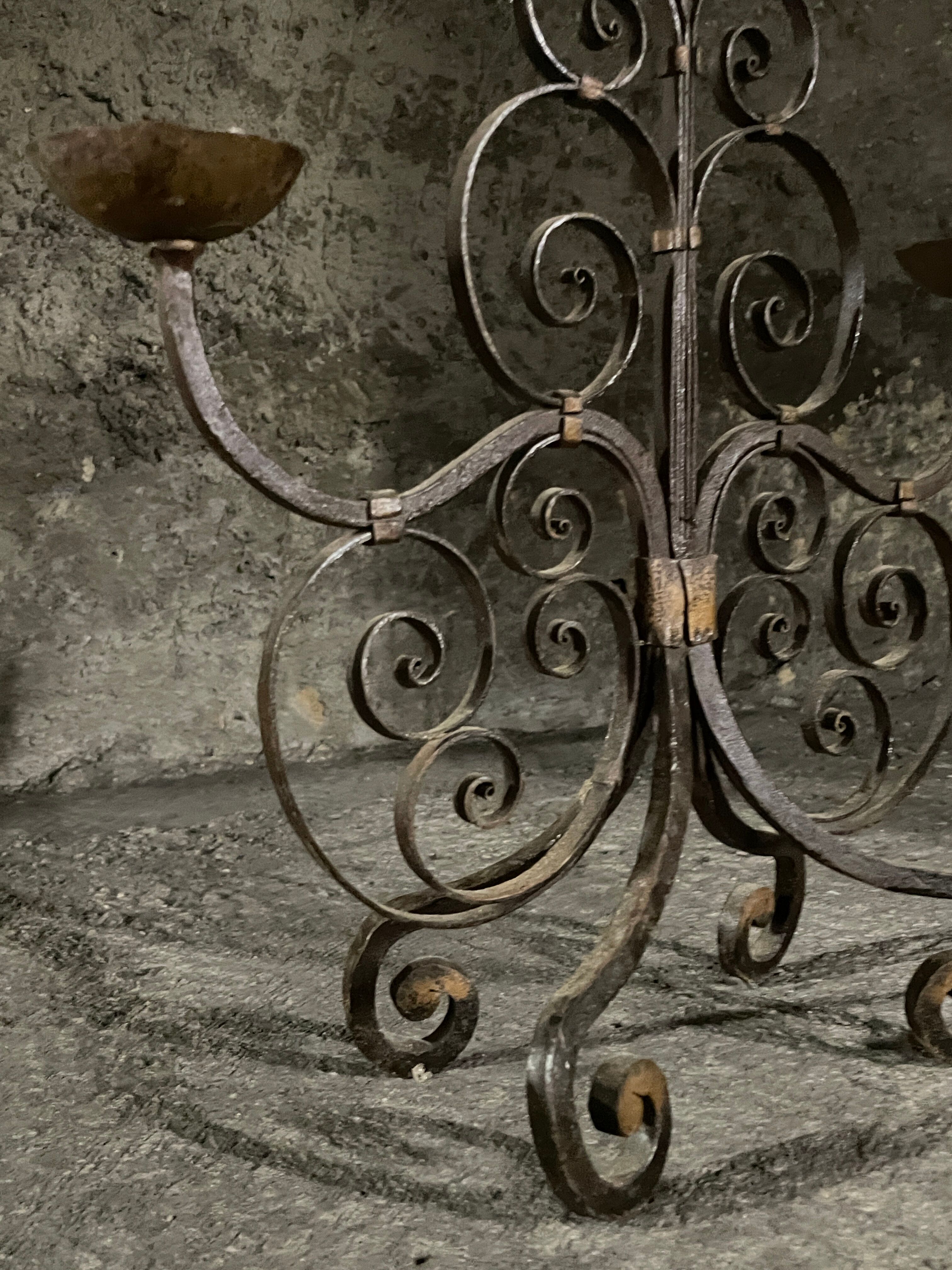 Pair of French wrought iron candelabra from the 19th century.