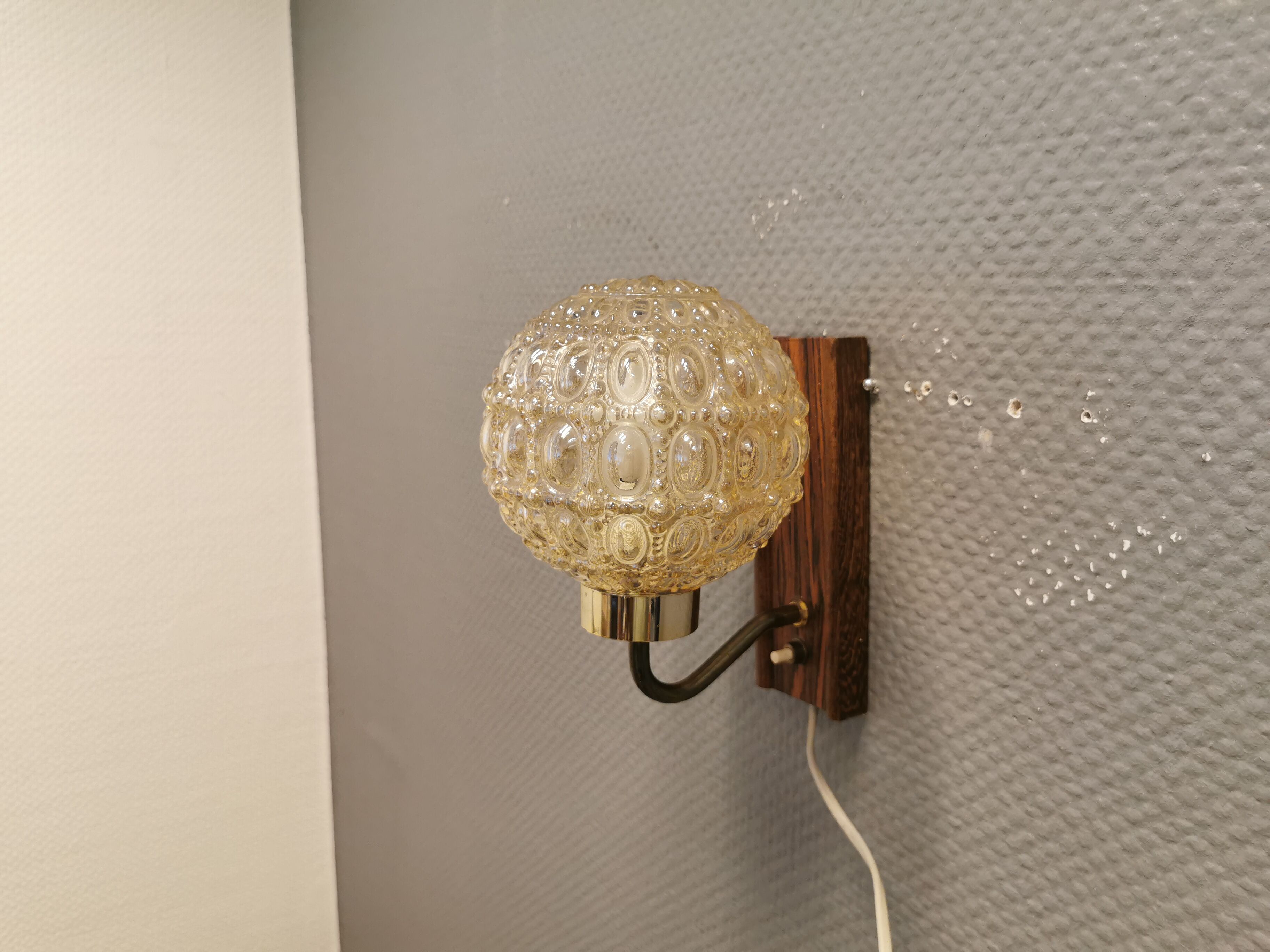 Wall light in rosewood with bobble glass ball shade.