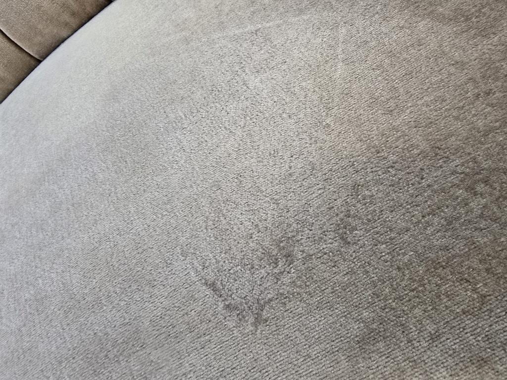 Vintage beige two-seater canapé with fringes.